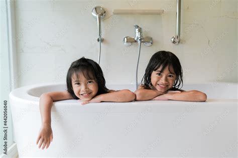 cute young girl lovers bathe together under a shower in a dark。